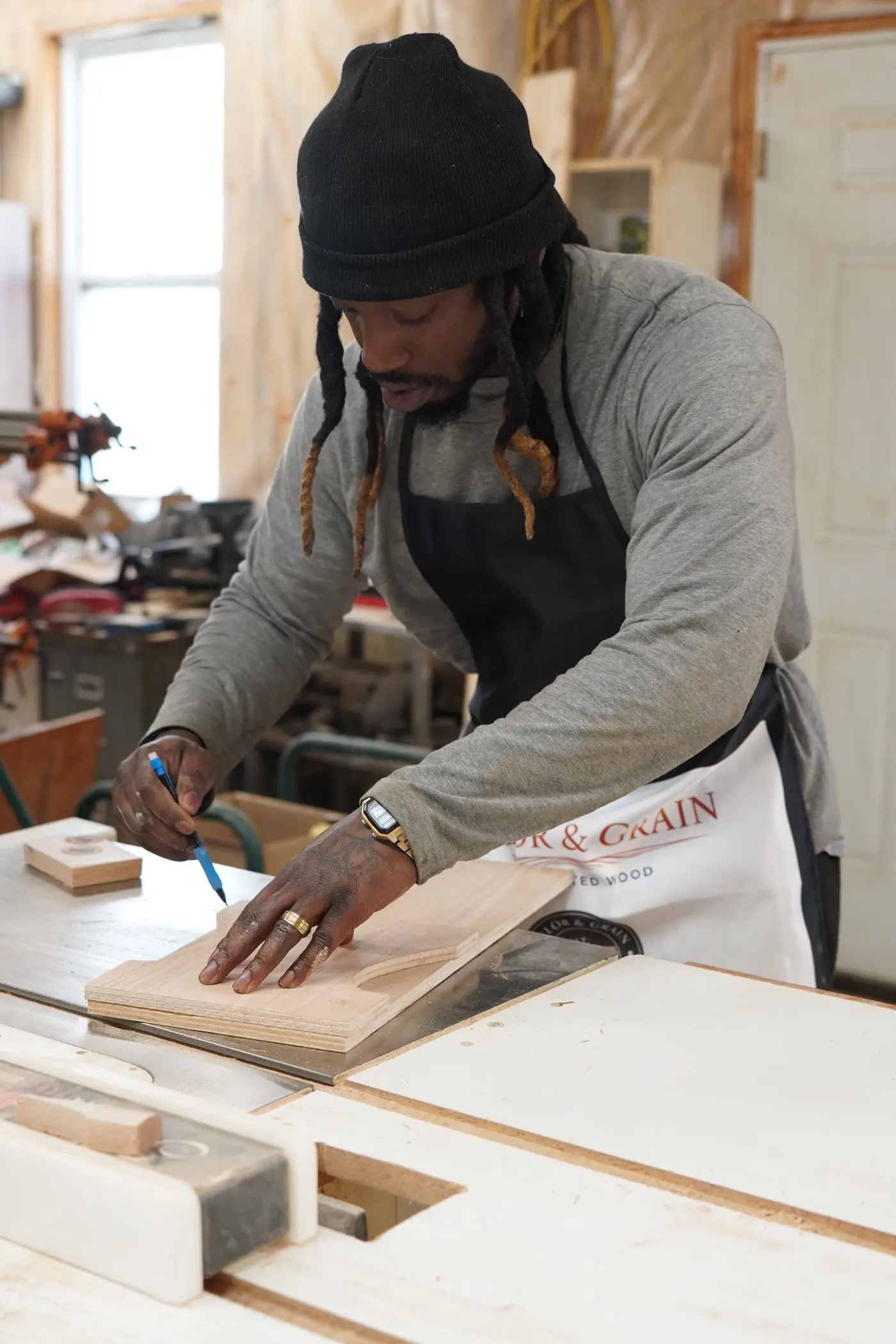 Dan marking a stool template at the table saw at Taylor & Grain