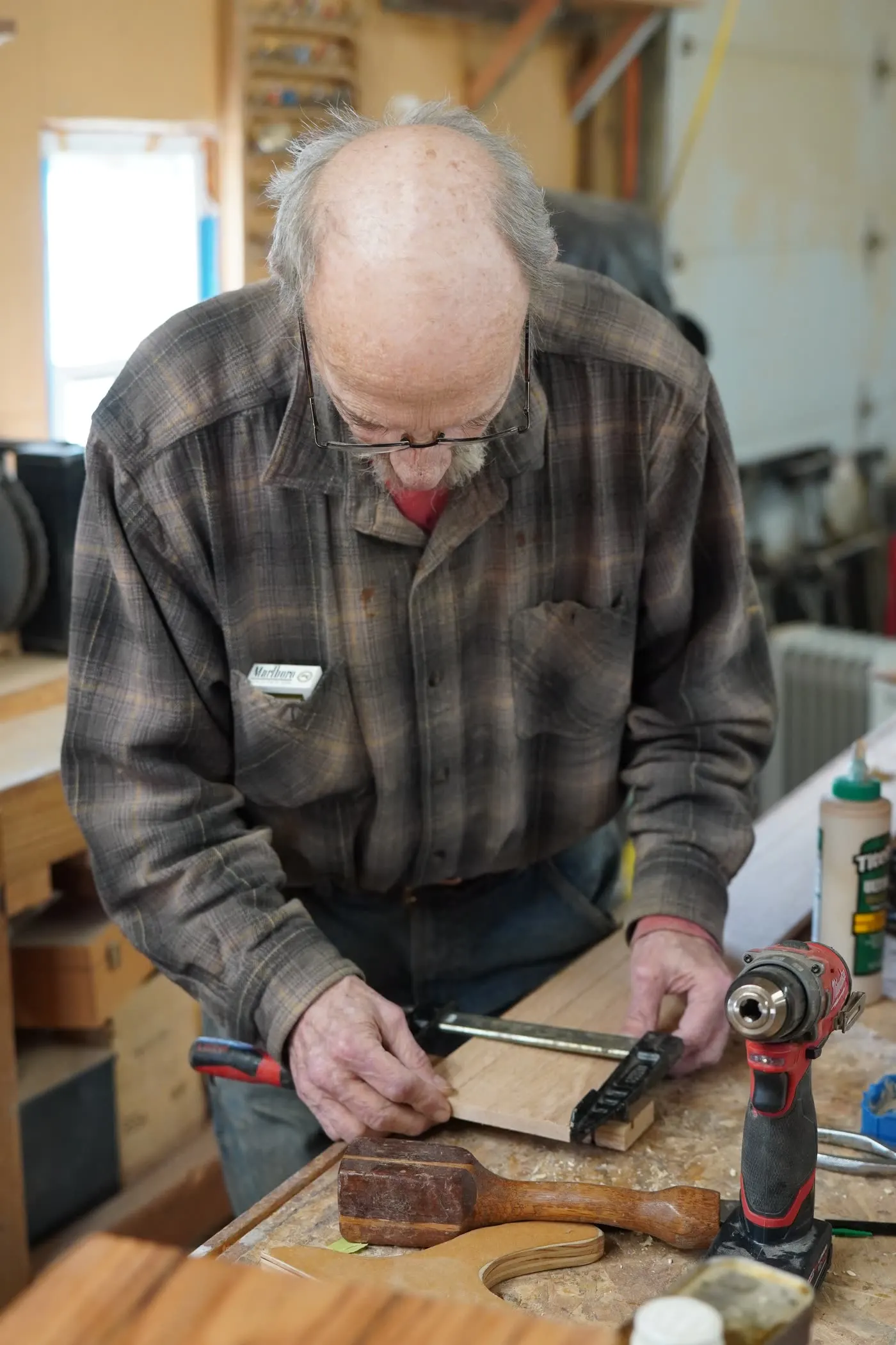 The owner clamping a hardwood board at the Taylor & Grain workbench